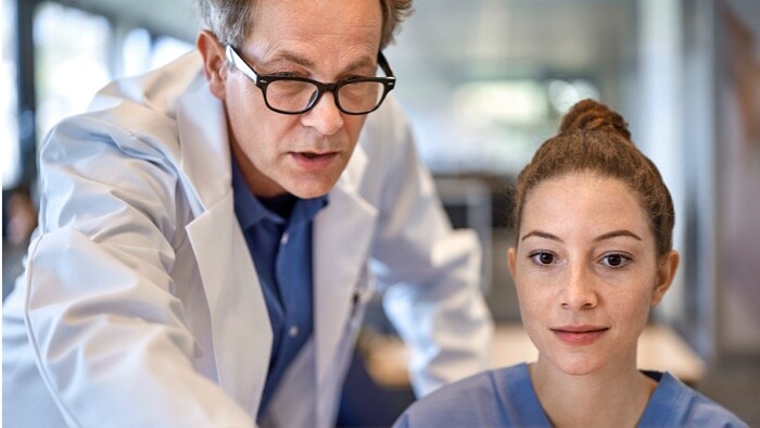 Two clinicians checking monitor