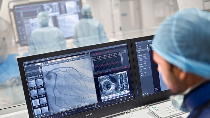 Doctor looking at screens twitter thumbnail