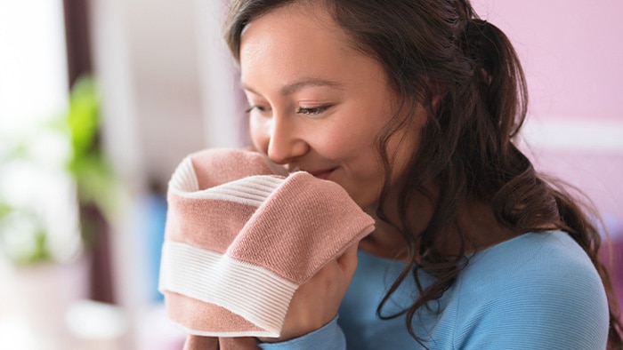 lady smelling freshly washed wool clothing